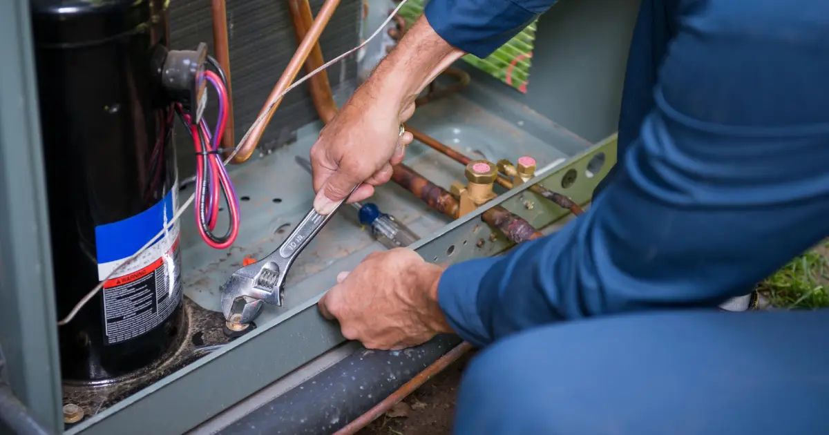 Service Man Repairing Air Conditioner - Meccom Air - HVAC Services in GTA