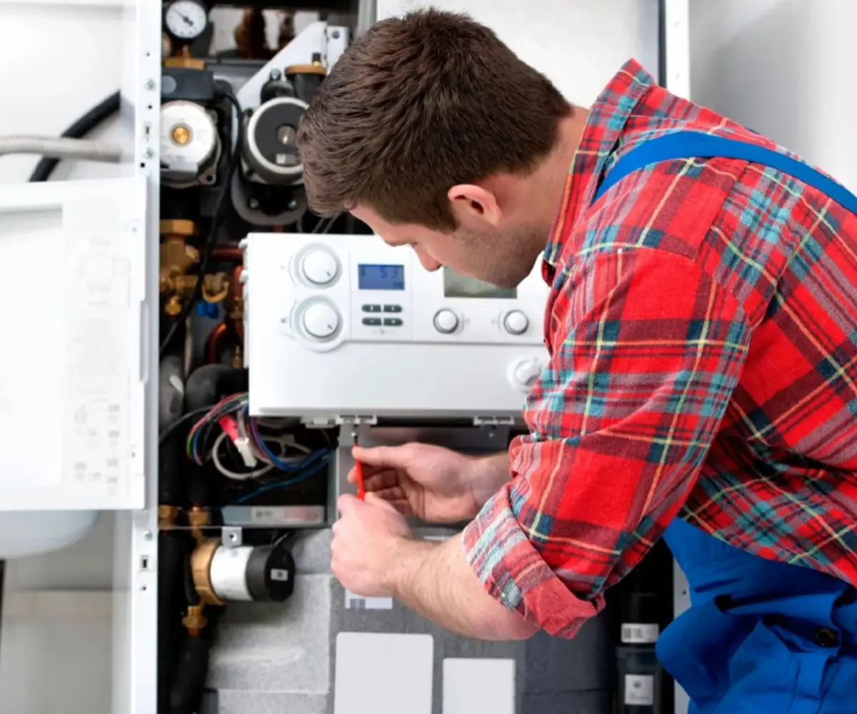 Service Man Repairing Tankless Water Heater - Meccom Air