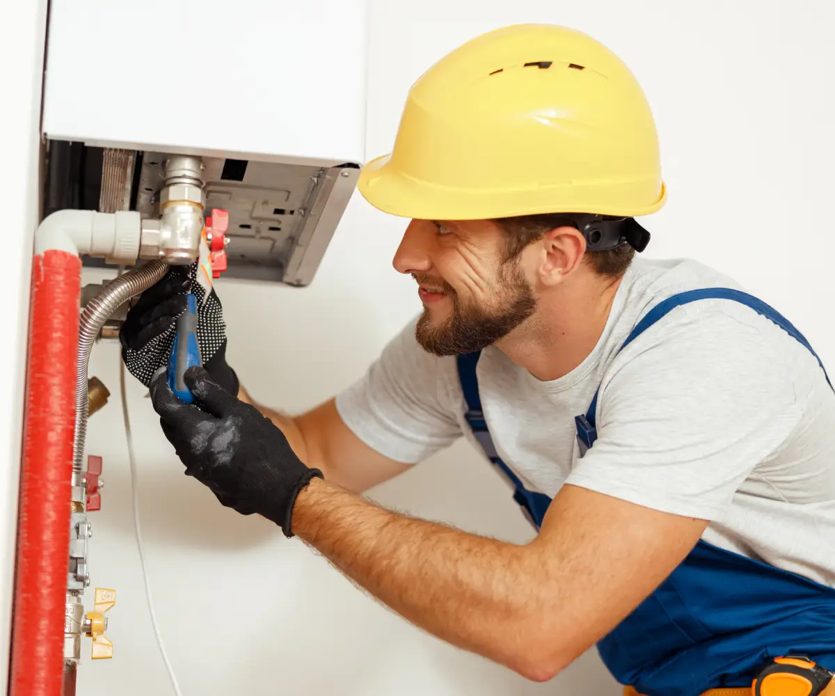 Technician Fixing Water Heater - Meccom Air